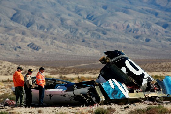 MOJAVE, CA - NOVEMBER 2 :  Sheriff's deputies inspect the wreckage of the Virgin Galactic SpaceShip 2 in a desert field November 2, 2014 north of Mojave, California on The Virgin Galactic SpaceShip 2 crashed on October 31, 2014 during a test flight, killing one pilot and seriously injuring another. (Photo by Sandy Huffaker/Getty Images)