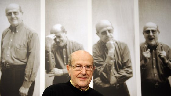 Portuguese director Manoel de Oliveira poses in front of a wall announcing an exhibition on his work on March 3, 2009 at the Akademie der Kuenste (Academy of Fine Arts) in Berlin. In collaboration with the Fundacao de Serralves - Museu de Arte Contemporanea, Porto, the academy presents from March 3 to 29, 2009 fifty film strips created by the 100-year-old artist during his more than 70 years lasting career.     AFP PHOTO    BARBARA SAX        (Photo credit should read BARBARA SAX/AFP/Getty Images)