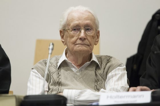 LUNEBURG, GERMANY - 21 APRIL: Oskar Groening, 93, arrives for the first day of his trial to face charges of being accomplice to the murder of 300,000 people at the Auschwitz concentration camp on April 21, 2015 in Lueneburg, Germany. Groening was an accountant with the Waffen SS and has been open about his role, claiming in interviews with media that he accepts his moral responsibility. Groening has also written an account of his experience, in what he claims is an effort to counter Holocaust revisionists. State prosecutors accuse Groening of accomplice in the murder of 300,000 Hungarian Jews who arrived at Auschwitz in 1944. (Photo by Andreas Tamme - Pool/Getty Images)