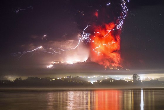 This view from Puerto Varas, southern Chile, shows a high column of ash and lava spewing from the Calbuco volcano, on April 23, 2015. Chile's Calbuco volcano erupted on Wednesday, spewing a giant funnel of ash high into the sky near the southern port city of Puerto Montt and triggering a red alert. Authorities ordered an evacuation for a 10-kilometer (six-mile) radius around the volcano, which is the second in southern Chile to have a substantial eruption since March 3, when the Villarrica volcano emitted a brief but fiery burst of ash and lava. AFP PHOTO/DAVID CORTES SEREY/AGENCIA UNO        (Photo credit should read DAVID CORTES SEREY/AFP/Getty Images)