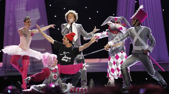 A streaker (C, wearing a red cap and a t-shirt reading "Jimmy Jump") appears on stage as Spain's Daniel Diges performs his song "Algo PequeÃ±ito (Something Tiny)" during the Eurovision Song Contest 2010 final at the Telenor Arena in Baerum, near Oslo, Norway, on May 29, 2010. The 55th annual competition was expected to be watched by more than 120 million viewers in 39 European countries.  Daniel Diges was allowed to perfom a second time at the end of the show.    AFP PHOTO / DANIEL SANNUM LAUTEN (Photo credit should read DANIEL SANNUM LAUTEN/AFP/Getty Images)