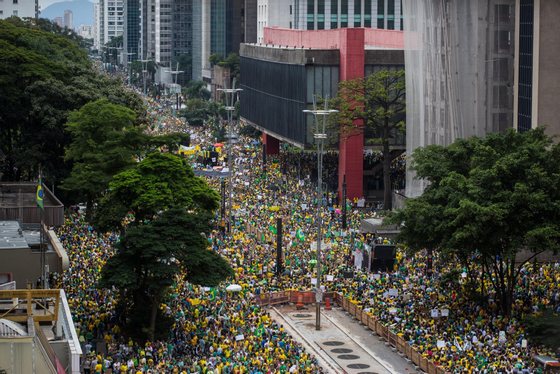 SAO PAULO, BRAZIL - MARCH 15: Anti-government protesters march along Avenida Paulista on March 15, 2015 in Sao Paulo, Brazil. Protests across the country were held today against President Dilma Rousseff's government with many protesters calling for her impeachment. A massive corruption scandal at Brazil's state-owned oil company Petrobras has rocked the government and Dilma's approval ratings are now around 23 percent. (Photo by Victor Moriyama/Getty Images)