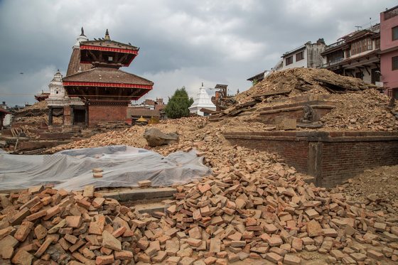 LALITPUR, NEPAL - APRIL 28:  Remains of a collapsed temple in the UNESCO World Heritage Site of Patan Durbar Square on April 28, 2015 in Lalitpur, Nepal. A major 7.8 earthquake hit Kathmandu mid-day on Saturday, and was followed by multiple aftershocks that triggered avalanches on Mt. Everest that buried mountain climbers in their base camps. Many houses, buildings and temples in the capital were destroyed during the earthquake, leaving thousands dead or trapped under the debris as emergency rescue workers attempt to clear debris and find survivors. Regular aftershocks have hampered recovery missions as locals, officials and aid workers attempt to recover bodies from the rubble.  (Photo by Omar Havana/Getty Images)