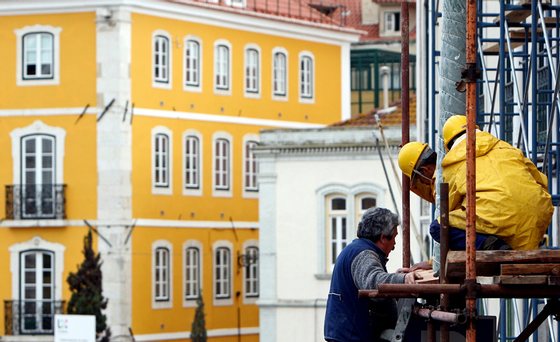 TO GO WITH AFP STORY IN FRENCH BY THOMAS CABRAL ---Construction workers mount a truss on a building in downtown Lisbon on February 4, 2009. Several buildings in Lisbon are undergoing renovations to restore them to their original look. For a long time promised, the makeover of the Baixa quarter, the historical centre of Lisbon which layed deteriorated and empty of inhabitants, is finally becoming a reality thanks to the town hall's renovations in the heart of the Portuguese capital. AFP PHOTO/ JOAO CORTESAO        (Photo credit should read JOAO CORTESAO/AFP/Getty Images)