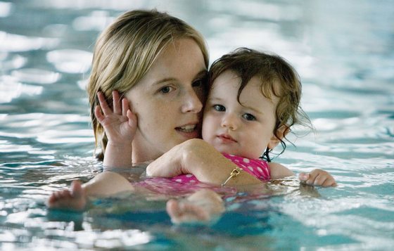 SYDNEY, AUSTRALIA - MARCH 16:  A mother and her daughter play in the water during a swimming class for babies at Lane Cove pool March 16, 2007 in Sydney, Australia. As the baby boom in Australia continues, the popularity of swimming classes for babies and toddlers is also on the increase. About 80% of the Australian population live on the coast, with swimming and surfing being major pastimes, leading parents to introduce their kids to water at an early age.  (Photo by Ian Waldie/Getty Images)