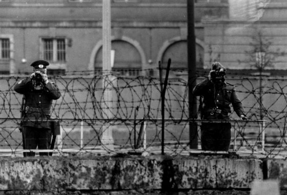 BERLIN - MAY 29:  East German guards watching over the Berlin wall during Queen Elizabeth and Prince Philip's visit to the city on May 29, 1965.   (Photo by J Wilds/Getty Images)