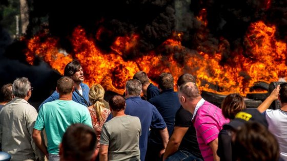 Striking employees of the My Ferry Link company block the access to the harbour after setting tyres on fire on July 31, 2015 in Calais, northern France, following the failure of negotiations with French government concerning job cuts.  AFP PHOTO PHILIPPE HUGUEN        (Photo credit should read PHILIPPE HUGUEN/AFP/Getty Images)