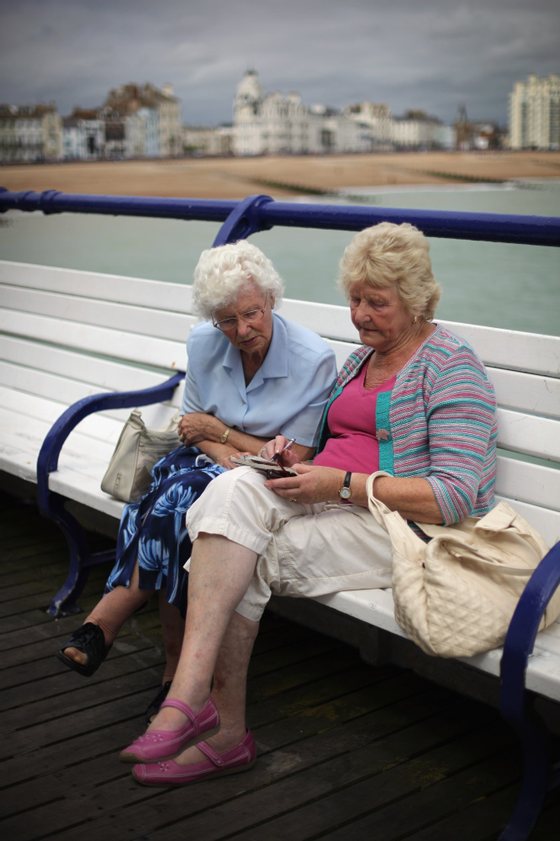 EASTBOURNE, ENGLAND - AUGUST 21: Two women complete a crossword on the pier at Eastbourne on August 21, 2010 in Eastbourne, England. Beach and seaside breaks in the UK have become increasingly popular due to people's nostalgic memories of growing up, according to the British tourist authority, VisitBritain. (Photo by Dan Kitwood/Getty Images)