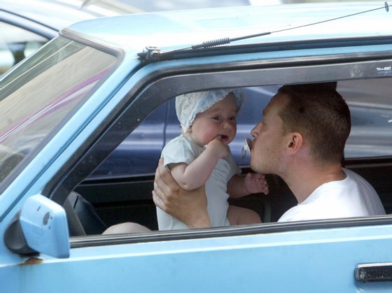 Kiev, UKRAINE:  A man holds the pacifier in his mouth as he nurses with his baby inside the car in downtown Kiev 13 July 2005. AFP PHOTO / SERGEI SUPINSKY  (Photo credit should read SERGEI SUPINSKY/AFP/Getty Images)