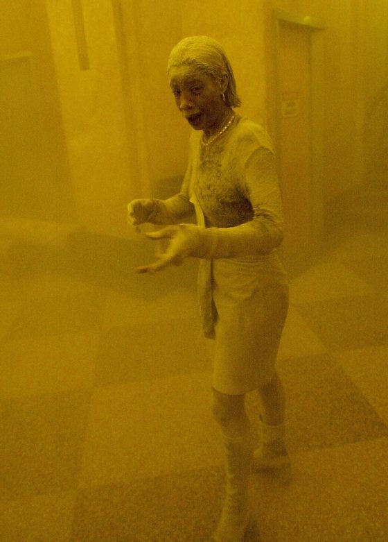New York, UNITED STATES: TO GO WITH AFP STORY "Americans mark 9/11 anniversary with new questions on vulnerability" - This 11 September 2001 file photo shows Marcy Borders covered in dust as she takes refuge in an office building after one of the World Trade Center towers collapsed in New York. Borders was caught outside on the street as the cloud of smoke and dust enveloped the area. The woman was caught outside on the street as the cloud of smoke and dust enveloped the area. AFP PHOTO/Stan HONDA (Photo credit should read STAN HONDA/AFP/Getty Images)
