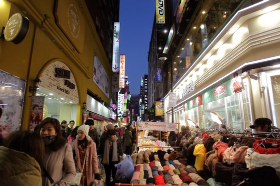 SEOUL, SOUTH KOREA - DECEMBER 11: Tourists window shop in the MyungDong shopping district on December 11, 2012 in Seoul, South Korea. One of the main South Korean presidential election campaign issues is the economy, as the chaebol, South Korea's business conglomerate, dominates the country's wealth while the economic life of middle class people has not been improving. (Photo by Chung Sung-Jun/Getty Images)