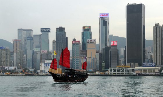 This photo taken on March 13, 2014 shows the Aqua Luna, one of Hong Kongs last remaining traditional Chinese junks, sailing past Hong Kong's skyline. Hong Kong's economy is expected to expand at its fastest pace in three years in 2014, the government said on February 26, while slashing public welfare spending as it cautioned over global economic headwinds and projected a narrowing budget surplus. AFP PHOTO / Laurent FIEVET (Photo credit should read LAURENT FIEVET/AFP/Getty Images)