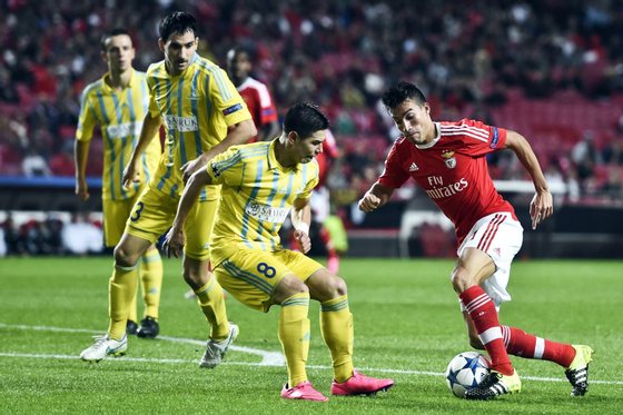 Benfica's Argentinian midfielder Nico Gaitan (R) vies with Astana's midfielder Georgi Zhukov (C) during the UEFA Champions League football match SL Benfica vs FC Astana at the Luz stadium in Lisbon on September 15, 2015. AFP PHOTO/ FRANCISCO LEONG (Photo credit should read FRANCISCO LEONG/AFP/Getty Images)