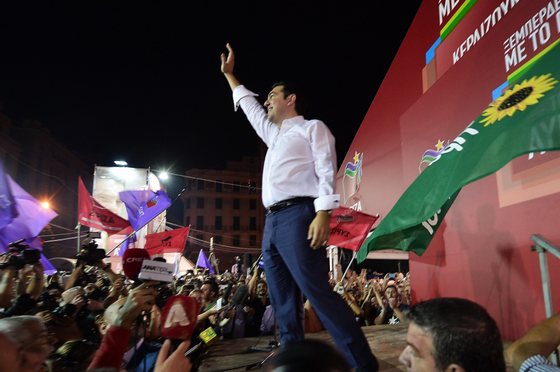 Syriza leader Alexis Tsipras celebrates with crowds after his party's victory at the Greek general elections in Athens on September 20, 2015. With over half of the votes counted, Tsipras' Syriza party won 35.54 percent of the vote against 28.07 percent for conservative New Democracy and is likely to again form a coalition government with the nationalist Independent Greeks (ANEL) party. AFP PHOTO/ LOUISA GOULIAMAKI (Photo credit should read LOUISA GOULIAMAKI/AFP/Getty Images)