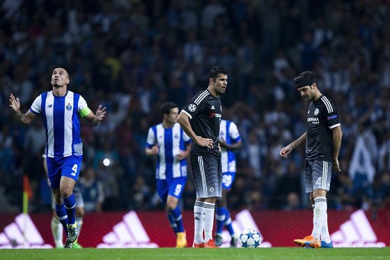 PORTO, PORTUGAL - SEPTEMBER 29: Diego Costa (2ndR) and his teammate Cesc Fabregas (R) react defeated as Maicon Pereira (L) of FC Porto celebrates his team's second goal during the UEFA Champions League Group G match between FC Porto and Chelsea FC at Estadio do Dragao on September 29, 2015 in Porto, Portugal. (Photo by Gonzalo Arroyo Moreno/Getty Images)