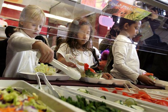 CHICAGO - MARCH 20: Students at Nettelhorst Elementary School, on lunch, dig into a salad bar in the school's lunchroom March 20, 2006 in Chicago, Illinois. U.S. Senator Dick Durbin (D-IL) stopped by the school to visit the new lunch program called, "Cool Foods," as part of the Healthy Schools Campaign. Nettelhorst is one of three Chicago public schools participating in the new lunch program offering salad bars. (Photo by Tim Boyle/Getty Images)