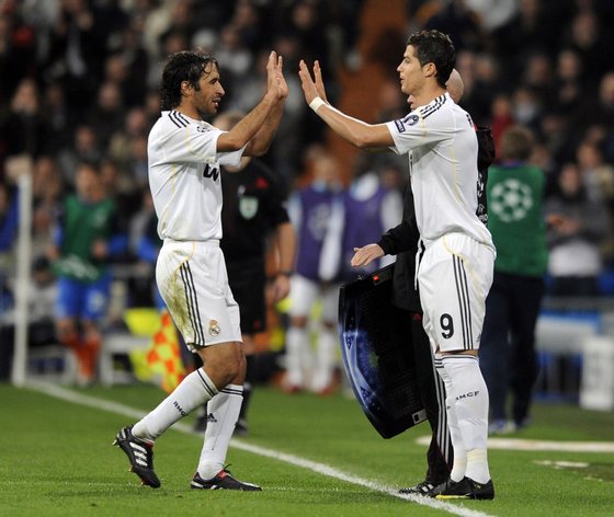 Real Madrid's Portuguese forward Cristiano Ronaldo (R) replaces Real Madrid's captain Raul Gonzalez (L) during a Champions league group C football match at Santiago Bernabeu stadium in Madrid on November 25, 2009. AFP PHOTO/JAVIER SORIANO. (Photo credit should read JAVIER SORIANO/AFP/Getty Images)