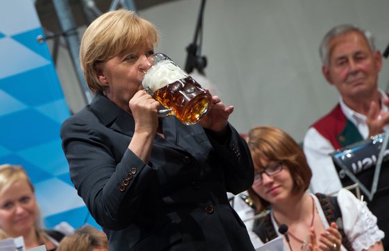 DACHAU, GERMANY - AUGUST 20: German Chancellor and Chairwoman of the German Christian Democrats (CDU) Angela Merkel drinks a beer after speaking at an election campaign stop in a fest tent on August 20, 2013 in Dachau, Germany. Merkel has a strong lead over her political rivals and the CDU is expected to win federal elections scheduled for September 22, though what kind of governing coalition the CDU will be able to form remains uncertain. (Photo by Joerg Koch/Getty Images)