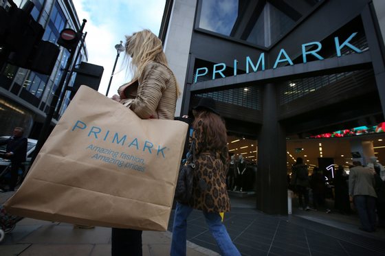 LONDON, ENGLAND - NOVEMBER 05:  A customer waits with her purchases outside Primark's flagship store on Oxford Street on November 5, 2014 in London, England. Retail giant Marks and Spencer have shown a continued decline in clothes sales as budget fashion chain Primark has delivered a 16% increase in its sales.  (Photo by Peter Macdiarmid/Getty Images)