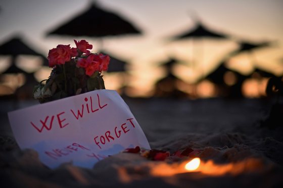 SOUSSE, TUNISIA - JUNE 28: A candle and flowers are left at Marhaba beach near to where 38 people were killed on Friday in a terrorist attack on June 28, 2015 in Souuse, Tunisia. Sousse beaches remain quiet following the Tunisia beach attack which left 38 dead, including at least 15 Britons while numerous tourists returned to the UK with more set to follow in the coming days. (Photo by Jeff J Mitchell/Getty Images)