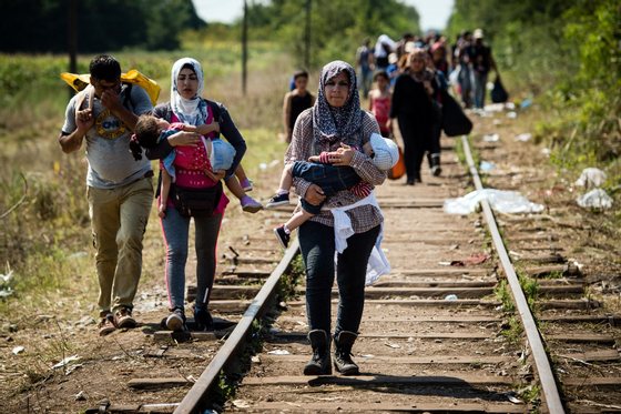 Migrants and refugees walk down railroad track towards the Hungarian border near the northern Serbian town of Horgos on August 27, 2015. As Hungary scrambles to ramp up defences on its border with Serbia, refugees continued to surge into the country in record numbers, police figures confirmed. AFP PHOTO / ANDREJ ISAKOVIC (Photo credit should read ANDREJ ISAKOVIC/AFP/Getty Images)