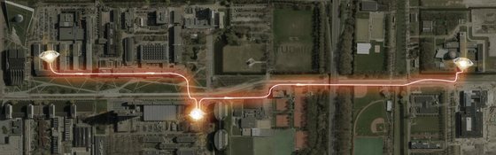 Photograph of the campus of Delft University of Technology showing the locations of the two electrons in the diamonds, and the intermediate measurement stations. Light shows the path the photons take that create the quantum link between the distant electrons.