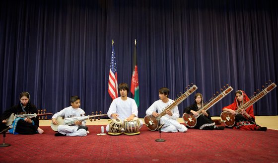 Negin Khpolwak (L), Gulalai Norestani (2nd R) and Huma Rahimy (R), members of the Afghanistan National Institute of Music Sitar and Sarod Ensemble, perform in the Dean Aceson Auditorium on February 4, 2013 in Washington, DC. The performance kicks of a three-city tour of the US. AFP PHOTO/Mandel NGAN (Photo credit should read MANDEL NGAN/AFP/Getty Images)