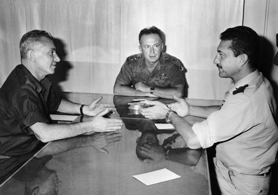 (from L to R) Israeli Deputy Chief of Staff in the the Israel Defense Forces (IDF) Haim "Kidoni" Bar-Lev, General and chief of staff of the IDF Yitzhak Rabin and General and IDF's Deputy Chief of Staff Ezer Weitzmann talk on June 6, 1967 about the military operation during the Six-Day War. AFP PHOTO (Photo credit should read DERZI/AFP/Getty Images)