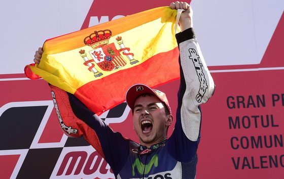 Movistar Yamaha's Spanish rider Jorge Lorenzo celebrates on the podium winning the race and the 2015 MotoGP world championship tiltle after the MotoGP motorcycling race at the Valencia Grand Prix at Ricardo Tormo racetrack in Cheste, near Valencia on November 8, 2015. AFP PHOTO / JAVIER SORIANO (Photo credit should read JAVIER SORIANO/AFP/Getty Images)