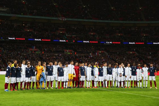 LONDON, ENGLAND - NOVEMBER 17: Both teams stand together for a moment of applause prior to the International Friendly match between England and France at Wembley Stadium on November 17, 2015 in London, England. (Photo by Paul Gilham/Getty Images)