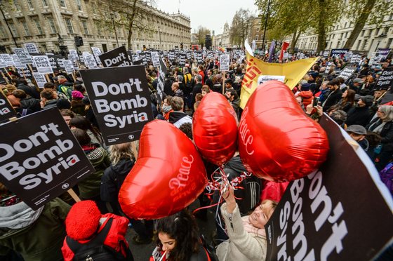 LONDON, ENGLAND - NOVEMBER 28: "Peace" balloons float up amongst "Don't bomb Syria signs" outside Downing Street against the possible British involvement in the bombing of Syria at Downing Street on November 28, 2015 in London, England. UK anti-war organisation, Stop the War Coalition, organised the protest in response to the proposed vote in Parliament by David Cameron to involve British forces in the bombing of ISIS targets in Syria. A similar protest in February 2003 against the British involvement in Iraq attracted a reported 2 million people to the streets of London. (Photo by Chris Ratcliffe/Getty Images)