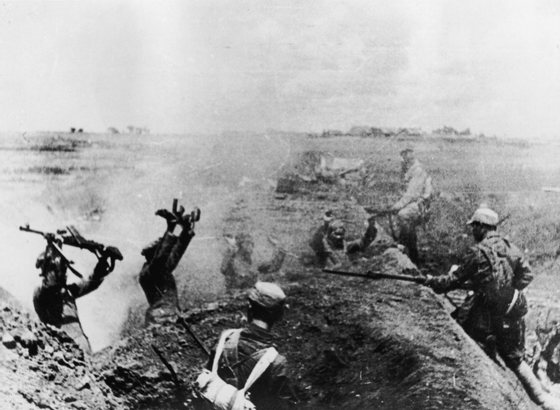 Chinese Communist troops take prisoners at bayonet point after heavy fighting in the attack on Shanghai, China on 21st May, 1949. The Chinese Civil War (1945 - 1949) ended with Communist victory in 1949. The defeated Nationalists were exiled to Taiwan. (Photo by Keystone/Hulton Archive/Getty Images)