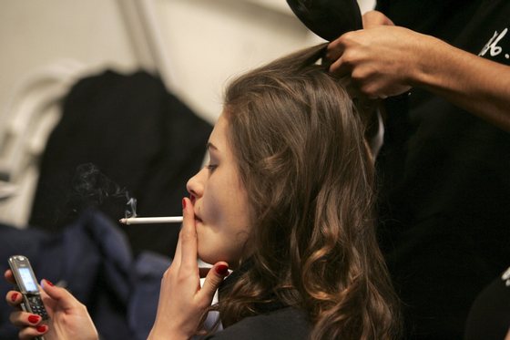 NEW YORK - FEBRUARY 07: A model smokes backstage at the Chaiken Fall 2006 fashion show during Olympus Fashion Week at Bryant Park February 6, 2006 in New York City. (Photo by Paul Hawthorne/Getty Images)