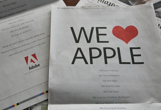 SAN FRANCISCO - MAY 13: A full page ad by Adobe Systems is displayed on the back of the San Francisco Chronicle business section May 13, 2010 in San Francisco, California. Adobe Systems has fired back at Apple CEO Steve Jobs' recent denouncement of Adobe's Flash technology and is running advertisements in major newspapers saying "We Love Apple". (Photo Illustration by Justin Sullivan/Getty Images)