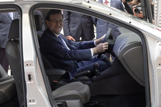 Spanish Prime Minister Mariano Rajoy smiles as he sits in a Seat car during a visit to the SEAT motor vehicle plant in Martorell near Barcelona on September 8, 2015 to celebrate the 40th anniversary of the plant's technical centre. AFP PHOTO / JOSEP LAGO (Photo credit should read JOSEP LAGO/AFP/Getty Images)