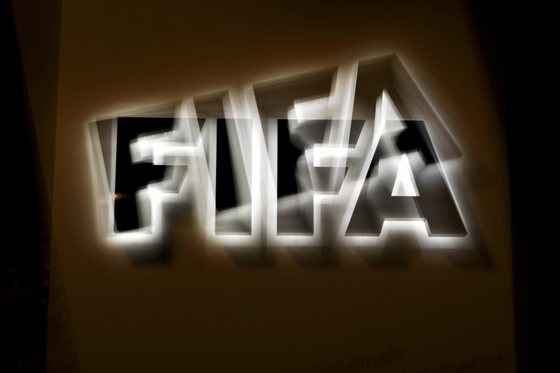 This long exposure photo taken on October 8, 2015 shows the FIFA logo at the entrance sign of the FIFA world headquarters in Zurich. FIFA's ethics watchdog on Thursday suspended the two most powerful men in football, Sepp Blatter and Michel Platini, for 90 days in a sensational new blow to the sport's scandal-tainted governing body. Issa Hiyatou head of the Confederation of African Football, a Blatter ally, was put in charge of the multi-billion dollar body. AFP PHOTO / FABRICE COFFRINI (Photo credit should read FABRICE COFFRINI/AFP/Getty Images)