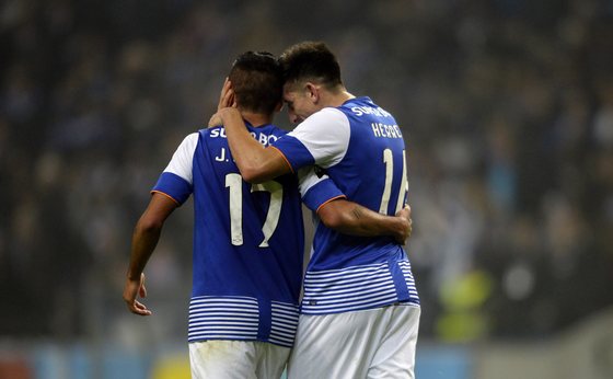 Porto's Mexican midfielder Hector Herrera (R) celebrates after scoring a goal with teammate Mexican forward Jesus Corona during the Portuguese league football match FC Porto vs A. Academica de Coimbra at the Dragao stadium in Porto on December 20, 2015. Porto won the match 3-1. AFP PHOTO / MIGUEL RIOPA / AFP / MIGUEL RIOPA (Photo credit should read MIGUEL RIOPA/AFP/Getty Images)