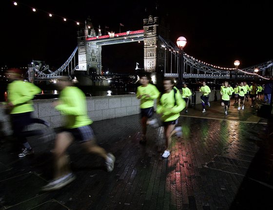 LONDON - NOVEMBER 28: Runners head past Tower Bridge during the Nike Run London 10k race on November 28, 2004 in London, England. (Photo by John Gichigi/Getty Images)
