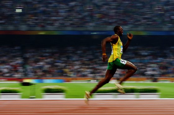 BEIJING - AUGUST 20: Usain Bolt of Jamaica competes on his way to breaking the world record with a time of 19.30 to win the gold medal in the Men's 200m Final at the National Stadium during Day 12 of the Beijing 2008 Olympic Games on August 20, 2008 in Beijing, China. (Photo by Julian Finney/Getty Images)