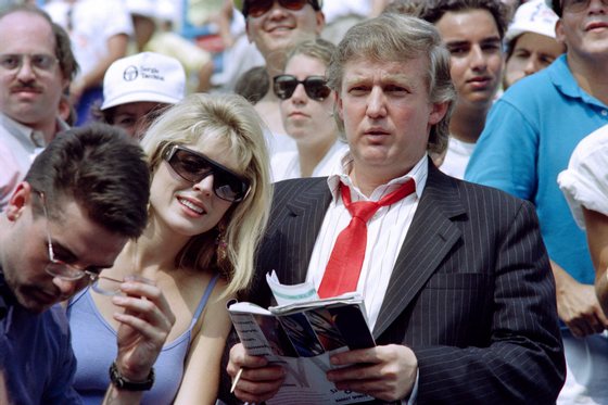 Developer Donald Trump (R) and his fiancee Marla Maples watch second round action at the US Open tennis tournament on August 28, 1991. AFP PHOTO TIMOTHY A. CLARY (Photo credit should read TIMOTHY A. CLARY/AFP/Getty Images)