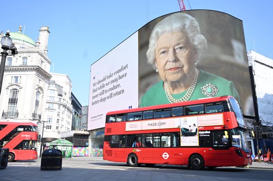 epaselect epa08352467 Britain's Queen Elizabeth and her message of hope are displayed on advertising boards at Piccadilly Circus in London, Britain, 09 April 2020. Countries around the world are taking increased measures to stem the widespread of the SARS-CoV-2 coronavirus which causes the Covid-19 disease. EPA/NEIL HALL