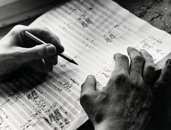 The German composer Carl Orff at work on a score