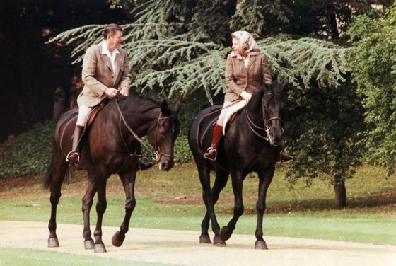 President Ronald Reagan and Queen Elizabeth II ride horses at Windsor, England.