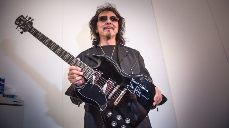 Tony Iommi, dos Black Sabbath, posa com uma Gibson Epiphone SG Signature em visita à feira de música Frankfurter Musikmesse, na Alemanha