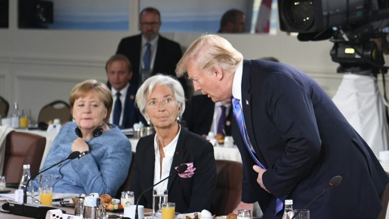 Donald Trump a falar com Christine Lagarde (diretora do FMI) e Angela Merkel (chanceler da Alemanha) durante a cimeira G7