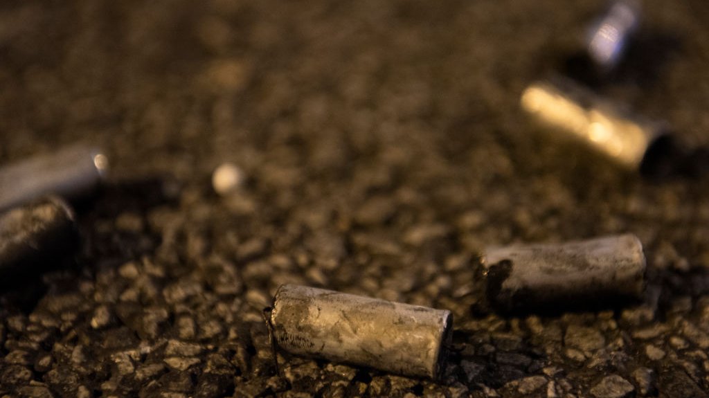 Bullet shells lay on the ground during the aftermath of the
