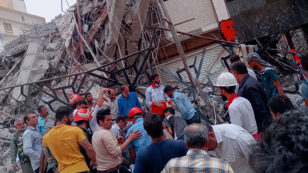 epa09969815 A handout picture made available by the Iranian red crescent official website (RCS) shows, members of the red crescent and officials work at the site where a ten-storey building collapsed the in city of Abadan, in Khuzestan province in southern of Iran, 23 May 2022. At least six people died and more than 32 people were injured, as initial estimates suggest around 80 people were trapped under rubble.  EPA/IRANIAN RED CRESCENT HANDOUT  HANDOUT EDITORIAL USE ONLY/NO SALES