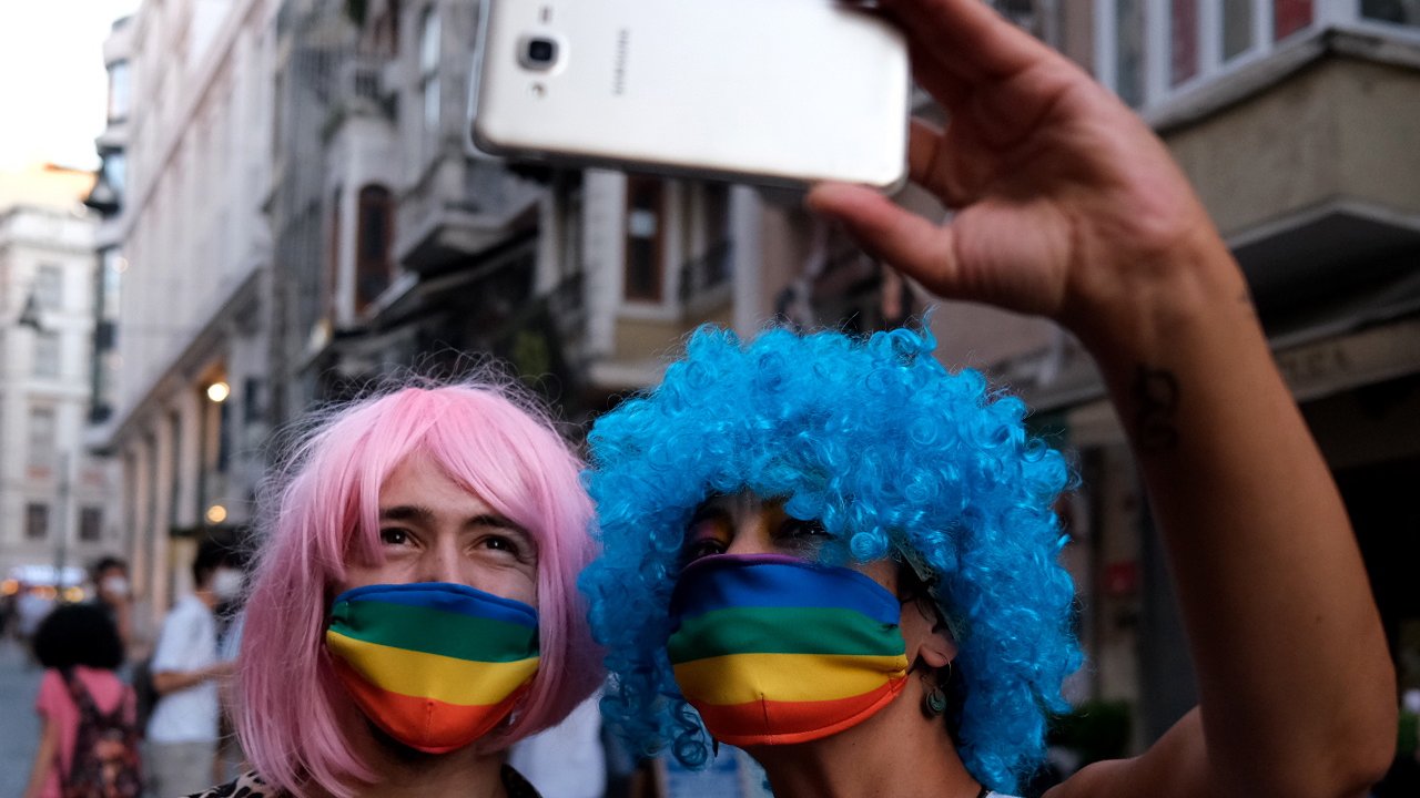 epa08514972 LGBTI (lesbian, gay, bisexual, transgender, and intersex) community members and supporters wear rainbow mask as they take selfie during the Global Pride in Istanbul, Turkey, 28 June 2020.  EPA/SEDAT SUNA