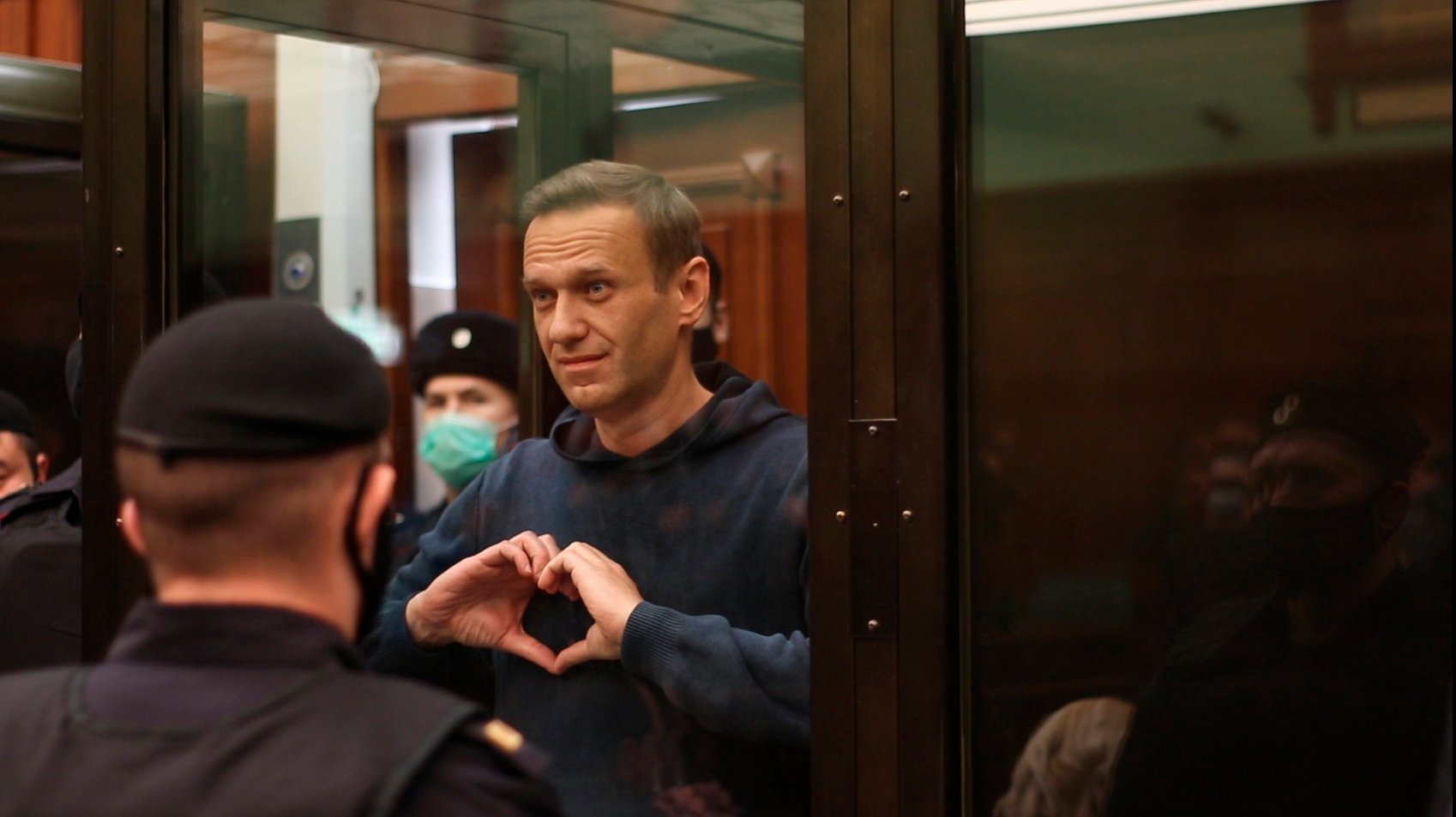 epa08982616 A still image taken from a handout video footage made available by the press service of the Moscow City Court shows an opposition leader Alexei Navalny gesturing from inside a defendant&#039;s glass cage during a visiting session of the Simonovsky district court at the Moscow City Court in Moscow, Russia, 02 February 2021. The visiting session of the Simonovsky city court decided to grant the Federal Penitentiary Service petition to replace the suspended sentence with a real one. 3.5 years in a general regime colony, while the time spent under house arrest during the investigation of the &#039;Yves Rocher&#039; case must be credited. Thus, when the sentence comes into force, the term will be 2 years 8 months. Opposition leader Alexei Navalny was detained after his arrival to Moscow from Germany on 17 January 2021. A Moscow judge on 18 January ruled that he will remain in custody for 30 days following his airport arrest.  EPA/MOSCOW CITY COURT PRESS SERVICE HANDOUT MANDATORY CREDIT HANDOUT EDITORIAL USE ONLY/NO SALES  EPA-EFE/MOSCOW CITY COURT PRESS SERVICE MANDATORY CREDIT HANDOUT EDITORIAL USE ONLY/NO SALES