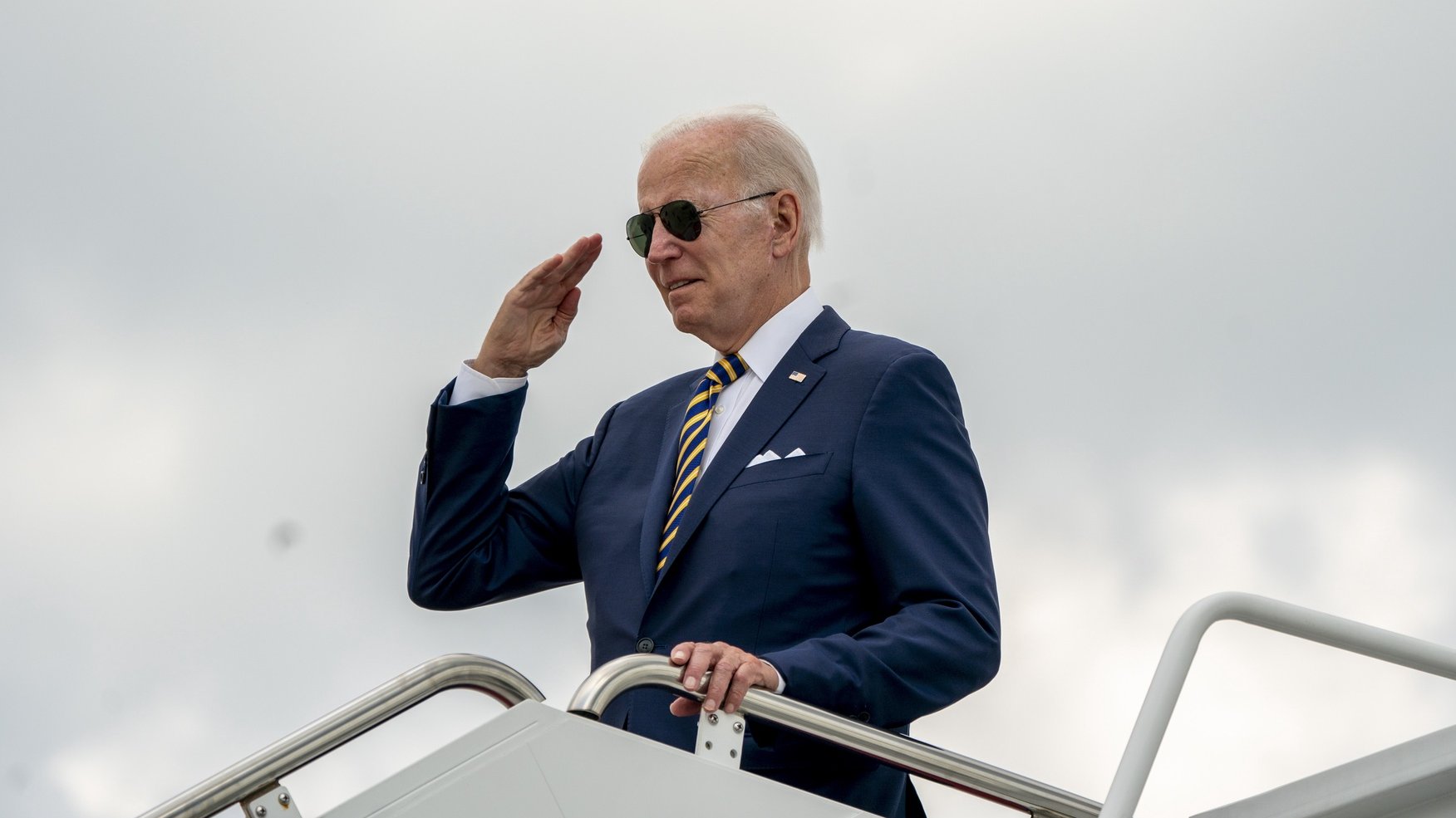 epa10114524 US President Joe Biden salutes as he boards Air Force One at Joint Base Andrews, Maryland, USA, 10 August 2022. Biden will be travelling to South Carolina on vacation.  EPA/SHAWN THEW